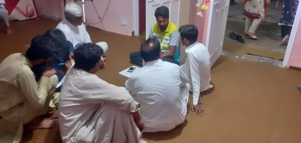 Men meeting in a circle on the floor