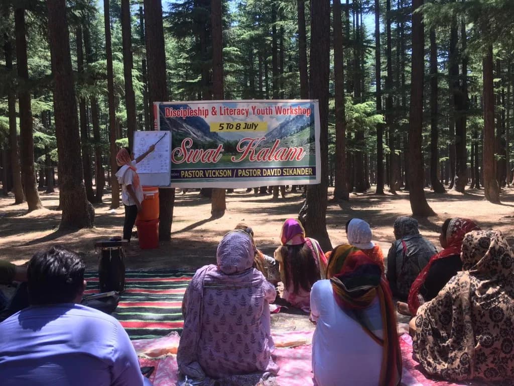 Youth literacy workshop outdoors in Swat Kalam