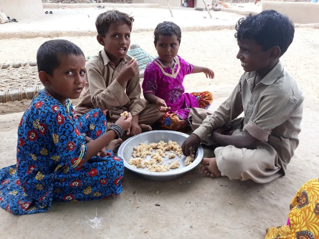 Four children sharing a communal meal together